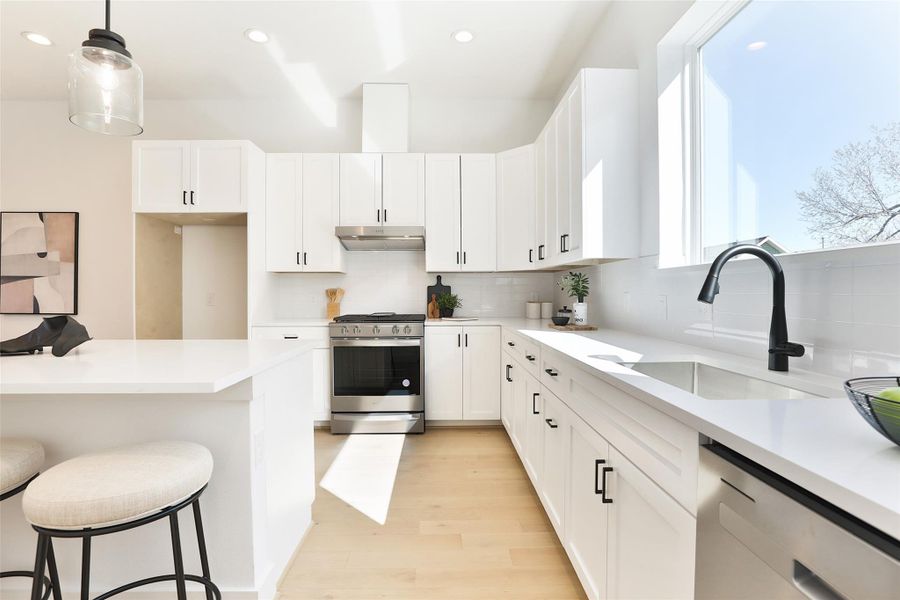 Take in the view from above your kitchen sink, complemented by 12x3 glossy white subway picket tiles.