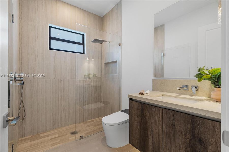 A third hallway bathroom serves the additional bedrooms and guests, offering convenience and functionality.