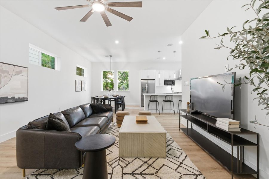 The living area completes the space with high ceilings and a comfortable, open feel - seamlessly tying together kitchen, dining, and everyday living.