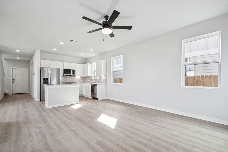 A kitchen with white cabinets.