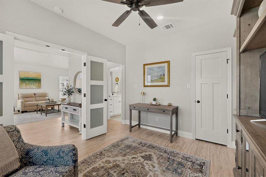 Office/Bedroom/flex space off the main living area with walk in closet and access to the jack and jill bathroom. The french doors with opaque glass add much needed privacy to the room