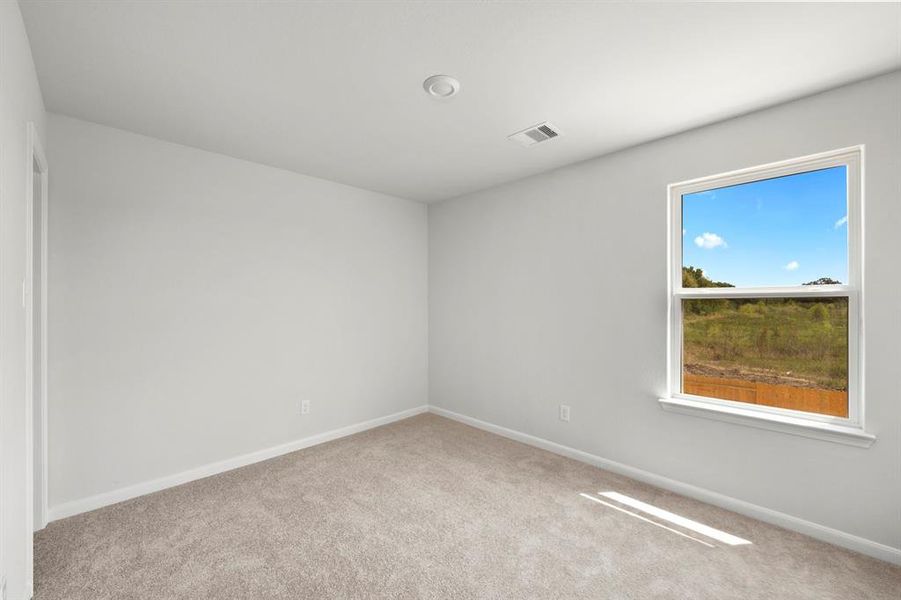 One of the two additional bedrooms in the home.