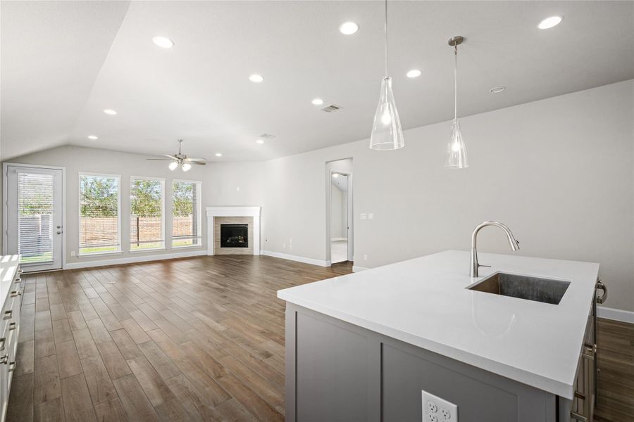 View from the island looking across the living space to the backyard access, emphasizing natural light and flow.