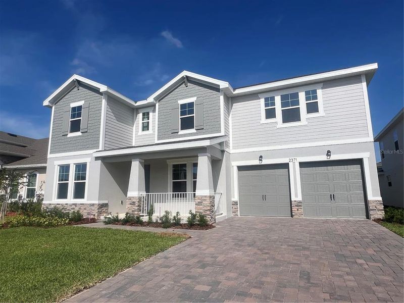 Front exterior of a new home in Hills of Minneola, Minneola, FL, highlighting curb appeal (Image 1). Front exterior of a new home in Hills of Minneola, Minneola, FL, highlighting curb appeal (Image 1).