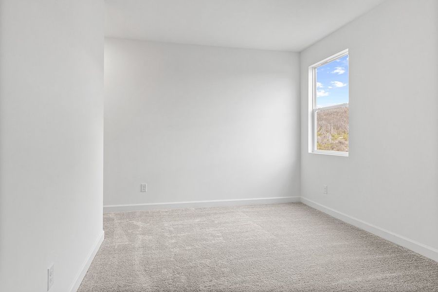 A room with a window and carpet. A room with a window and carpet.