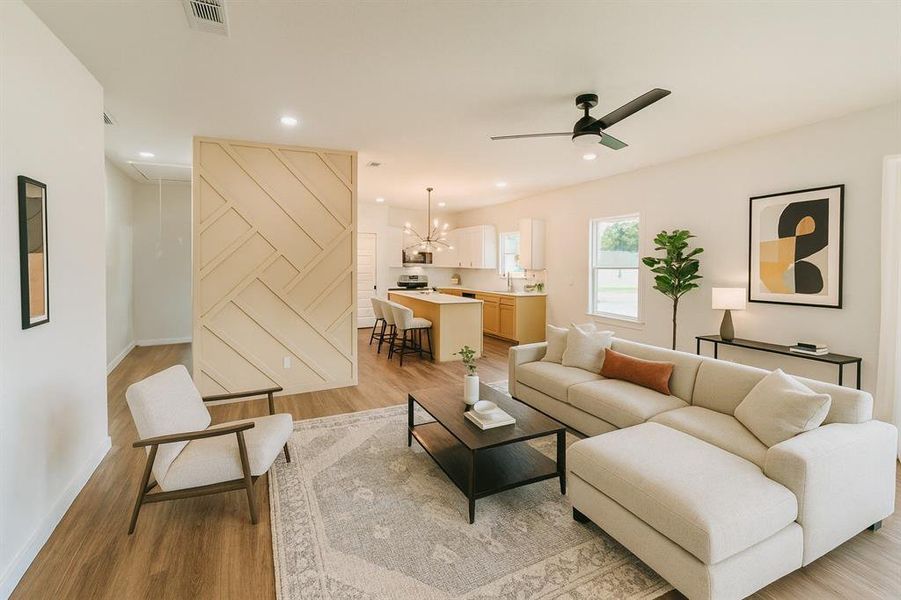 Living area with light wood-type flooring, recessed lighting, a ceiling fan, and a chandelier Living area with light wood-type flooring, recessed lighting, a ceiling fan, and a chandelier