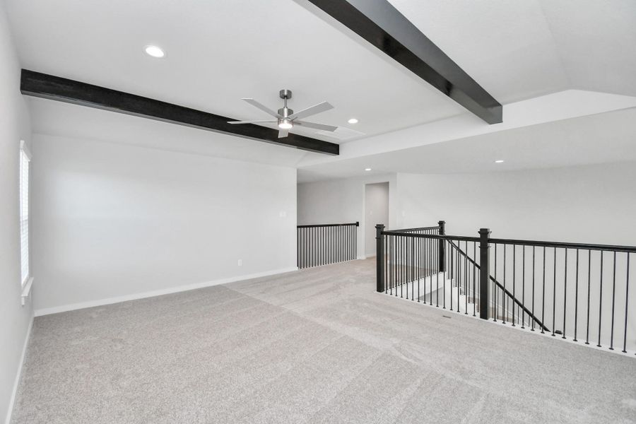 Come upstairs and enjoy a day of leisure in this fabulous game room! This is the perfect hangout spot or adult game room! Features plush carpet, high ceilings, custom paint and windows for plenty of natural light. Sample photo of completed home with similar floor plan. Actual colors and selections may vary.