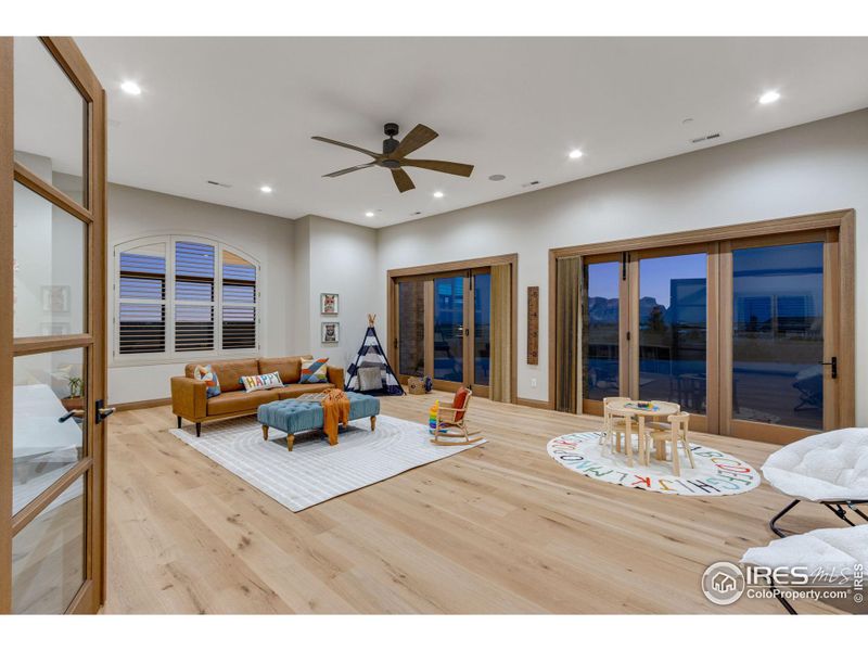 Play room with Double Rift White Oak French entry doors. This room is a flex space and can be an executive office, gym or main floor guest suite