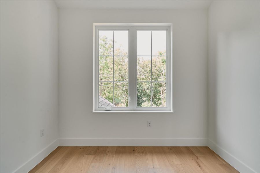 Unfurnished room featuring baseboards and light wood-style floors Unfurnished room featuring baseboards and light wood-style floors