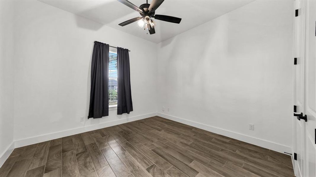 Empty room featuring ceiling fan and wood-type flooring