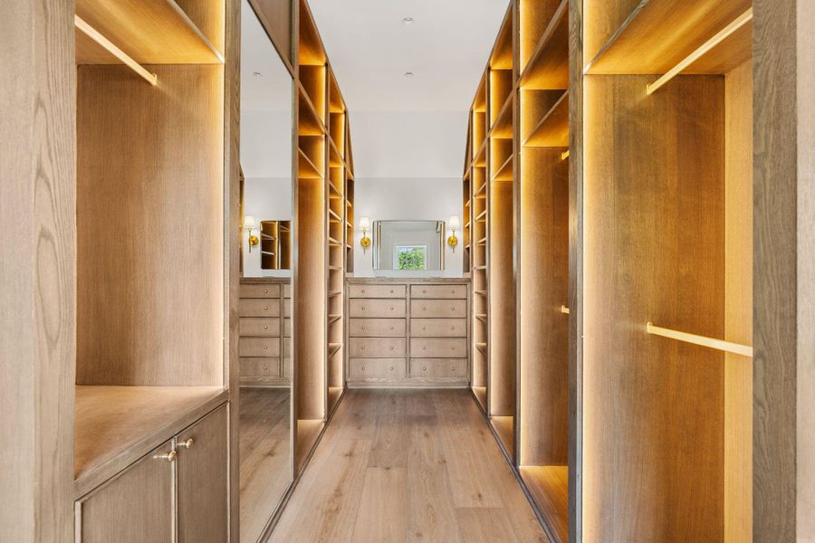 Enjoy a handsome closet with rift cut white oak cabinetry, built in dresser and lovely accent lighting. Enjoy a handsome closet with rift cut white oak cabinetry, built in dresser and lovely accent lighting.