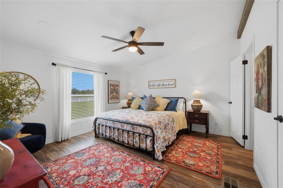 Spacious room featuring vaulted ceilings, wood-finish flooring, a contemporary ceiling fan, and ample natural light from the large window