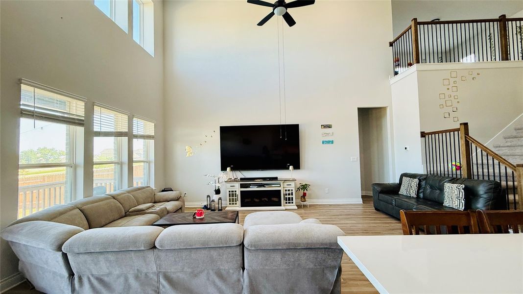A spacious, naturally illuminated living area with high ceilings and views of the outdoors.
