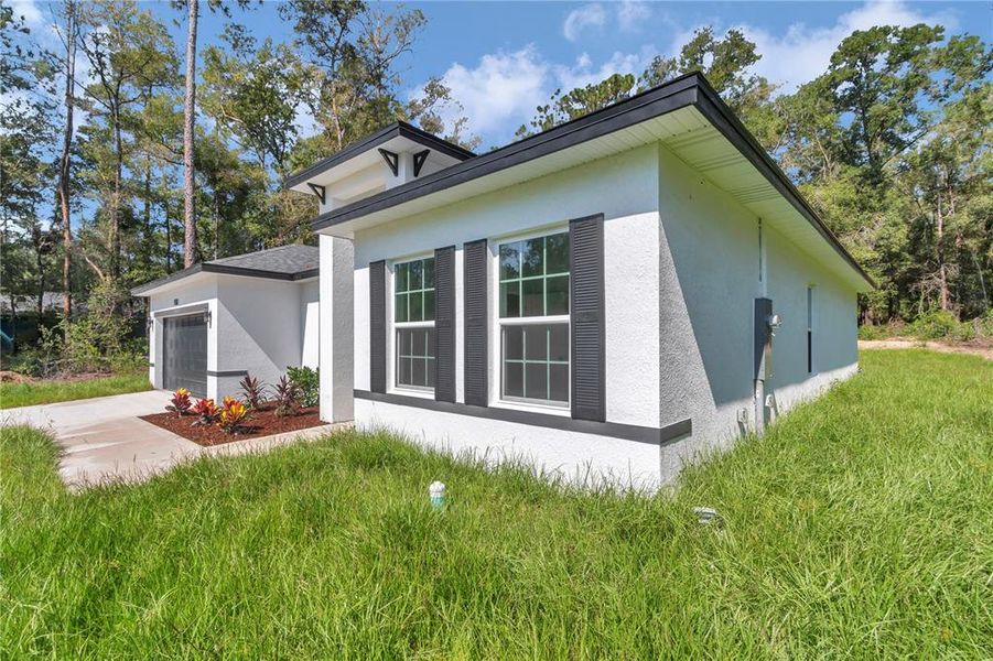 Front exterior of a new home in , Citrus Springs, FL, highlighting curb appeal (Image 1).