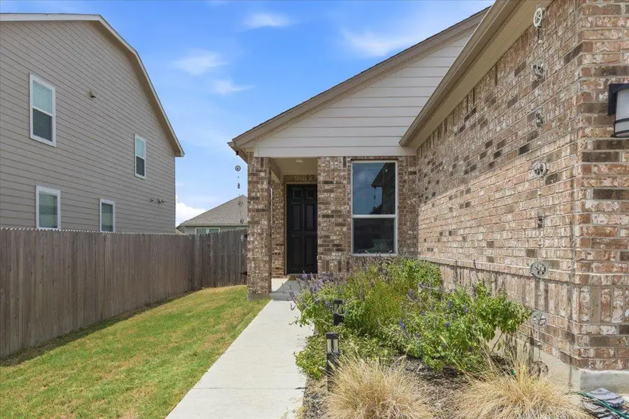 A welcoming brick exterior provides a warm invitation to this charming residence.