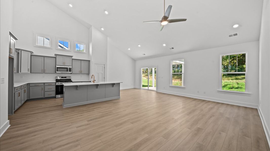 Tasteful family room with two-story volume, refined finishes, and exceptional natural light