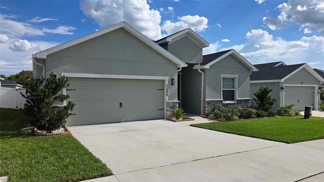 Front exterior of a new home in Geneva Landings, Davenport, FL, highlighting curb appeal (Image 2). Front exterior of a new home in Geneva Landings, Davenport, FL, highlighting curb appeal (Image 2).
