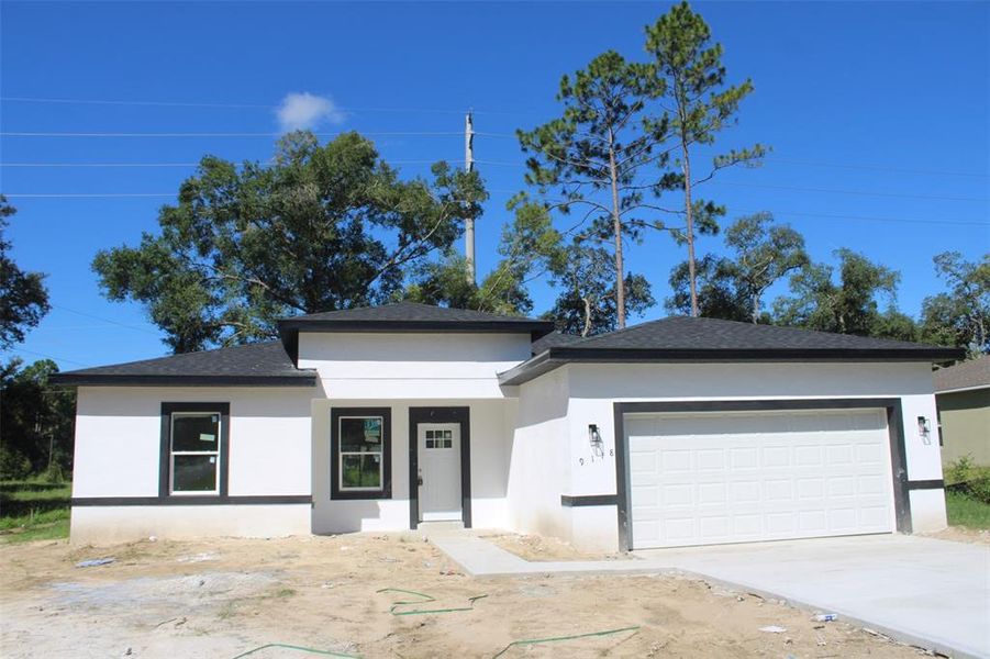 Front exterior of a new home in , Citrus Springs, FL, highlighting curb appeal (Image 1).