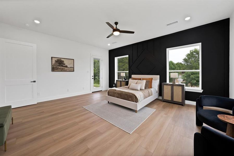 Spacious room featuring wood-finish flooring, a contemporary ceiling fan, and recessed lighting