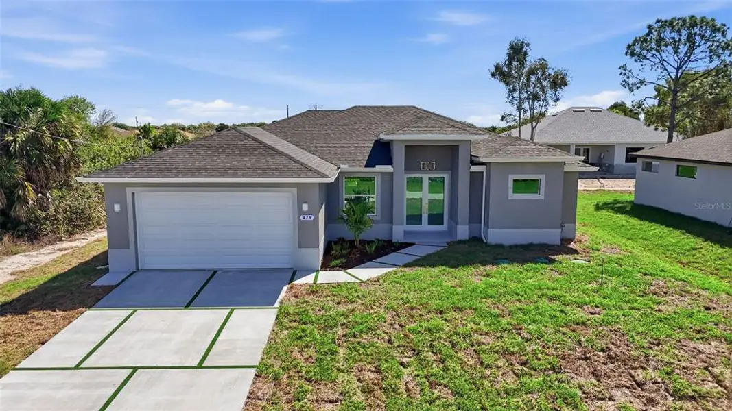 Front exterior of a new home in , Lehigh Acres, FL, highlighting curb appeal (Image 20).