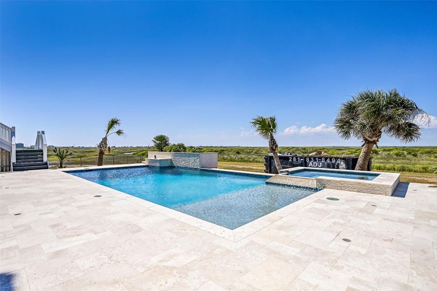 The 32,000 gallon saltwater pool and spa invite endless afternoons under the sun with waterfalls, bubblers, and panoramic Gulf views. Every detail was designed to feel like a private luxury resort.