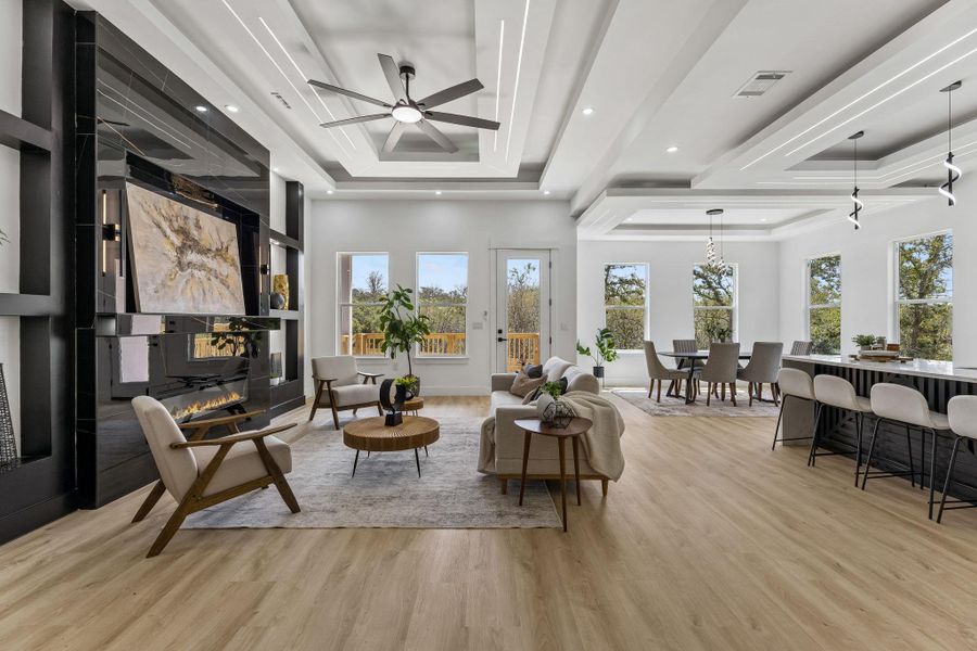 Gleaming hardwood floors and a modern linear fireplace anchor this open concept layout.