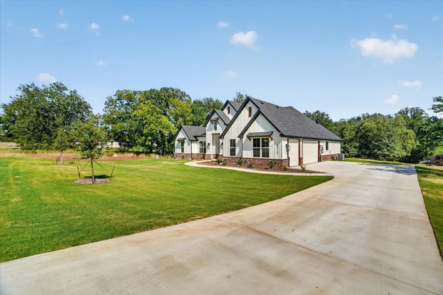 Front exterior of a new home in Cartwright Ranch, Weatherford, TX, highlighting curb appeal (Image 23). Front exterior of a new home in Cartwright Ranch, Weatherford, TX, highlighting curb appeal (Image 23).