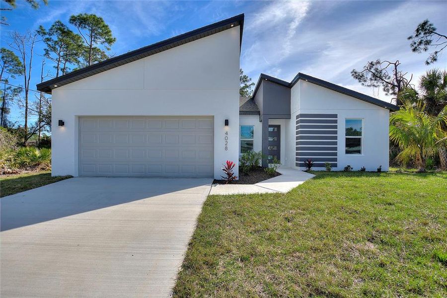 Front exterior of a new home in , North Port, FL, highlighting curb appeal (Image 18). Front exterior of a new home in , North Port, FL, highlighting curb appeal (Image 18).