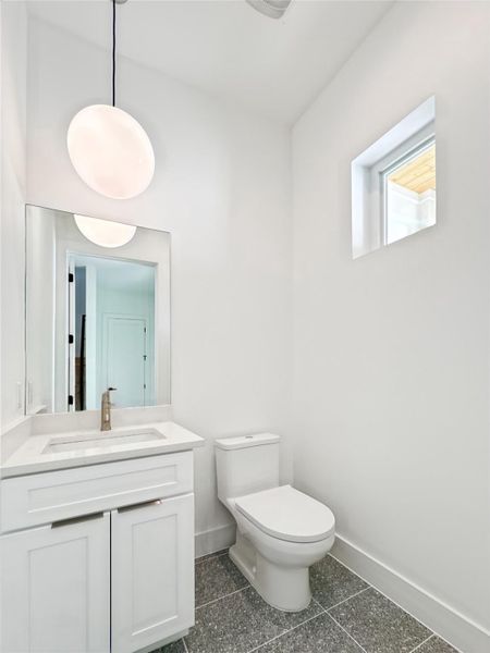 Half bathroom with baseboards, and vanity Half bathroom with baseboards, and vanity
