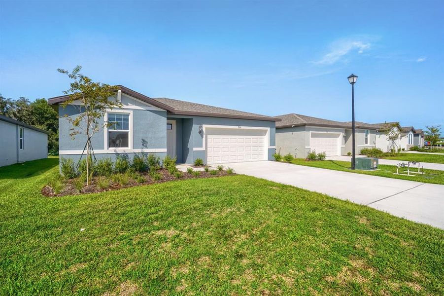 Front exterior of a new home in Salt Meadows - Classic Series, Parrish, FL, highlighting curb appeal (Image 19). Front exterior of a new home in Salt Meadows - Classic Series, Parrish, FL, highlighting curb appeal (Image 19).