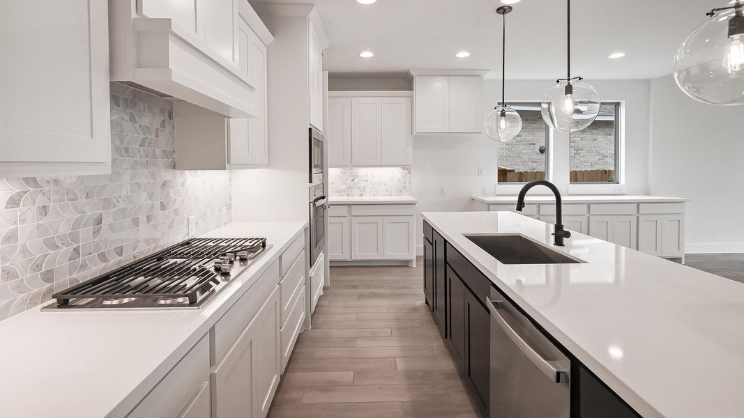 Kitchen featuring recessed lighting, a sink, light wood-style floors, light countertops, and appliances with stainless steel finishes