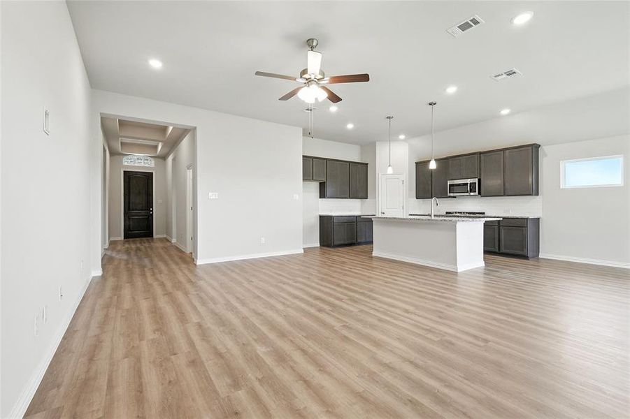 Unfurnished living room with light wood-style flooring, ceiling fan, and recessed lighting