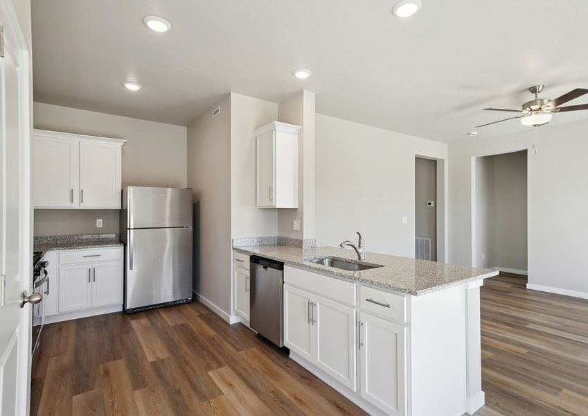 The kitchen has stainless steel appliances and plank flooring. The kitchen has stainless steel appliances and plank flooring.