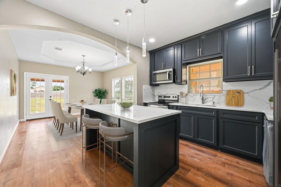 Virtually Staged: This stunning open-concept kitchen and dining area combines modern elegance with functional design.