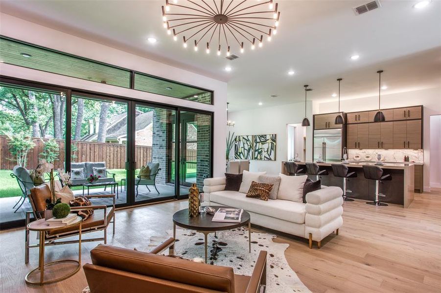 Living room featuring light wood-type flooring and a chandelier