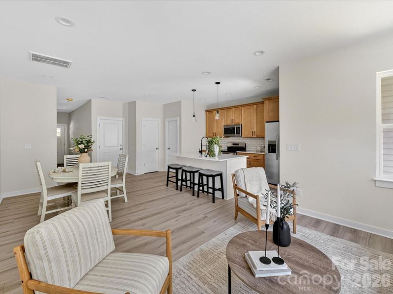 Bright and inviting family room filled with natural light, offering an open layout that seamlessly connects to the kitchen and dining area for comfortable everyday living. Bright and inviting family room filled with natural light, offering an open layout that seamlessly connects to the kitchen and dining area for comfortable everyday living.