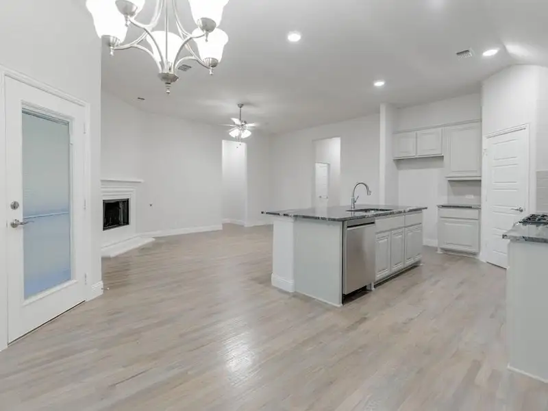 Unfurnished living room with light hardwood / wood-style flooring and ceiling fan