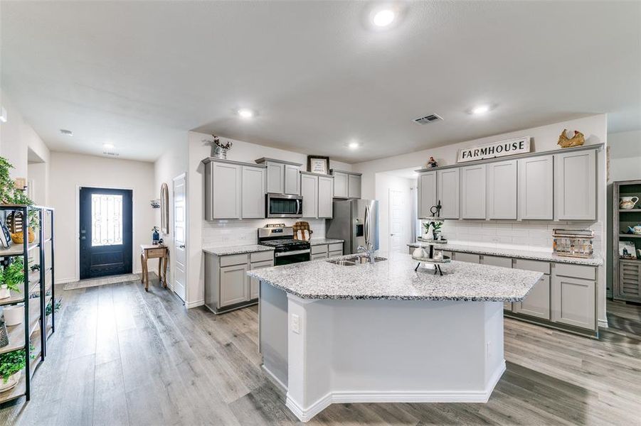 Kitchen featuring upgraded gray cabinetry