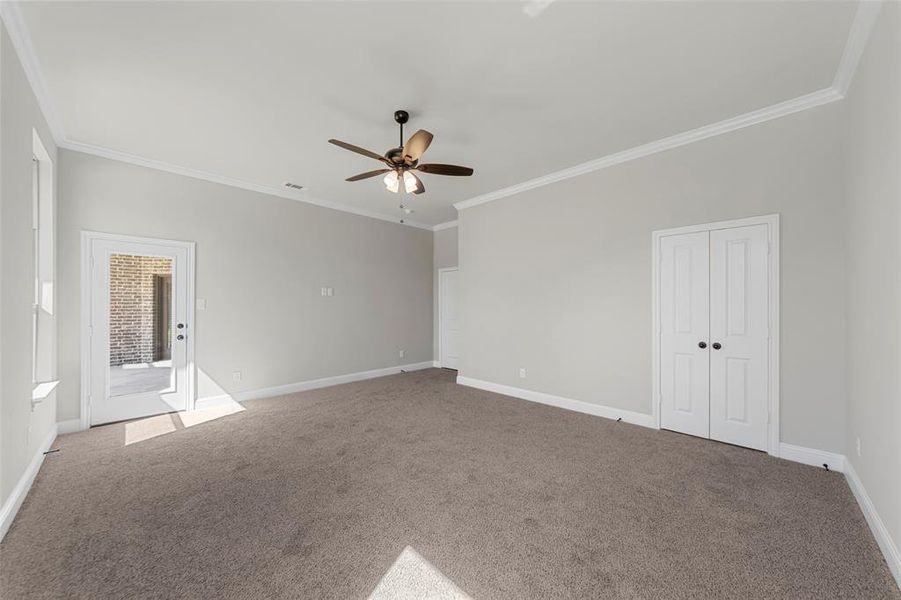 Spare room featuring ceiling fan, crown molding, carpet, and baseboards Spare room featuring ceiling fan, crown molding, carpet, and baseboards