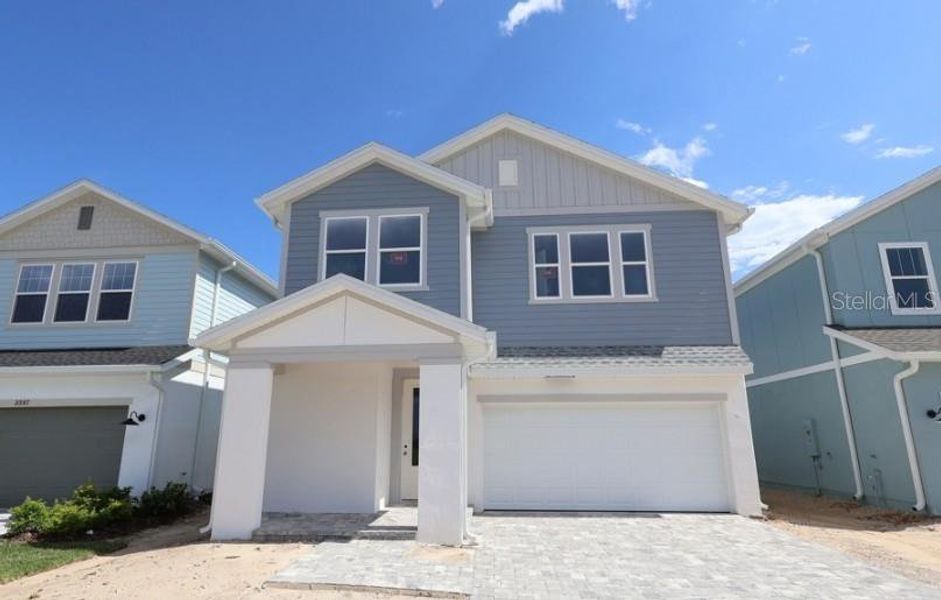 Front exterior of a new home in Persimmon Place – Garden Series, Wesley Chapel, FL, highlighting curb appeal (Image 2). Front exterior of a new home in Persimmon Place – Garden Series, Wesley Chapel, FL, highlighting curb appeal (Image 2).