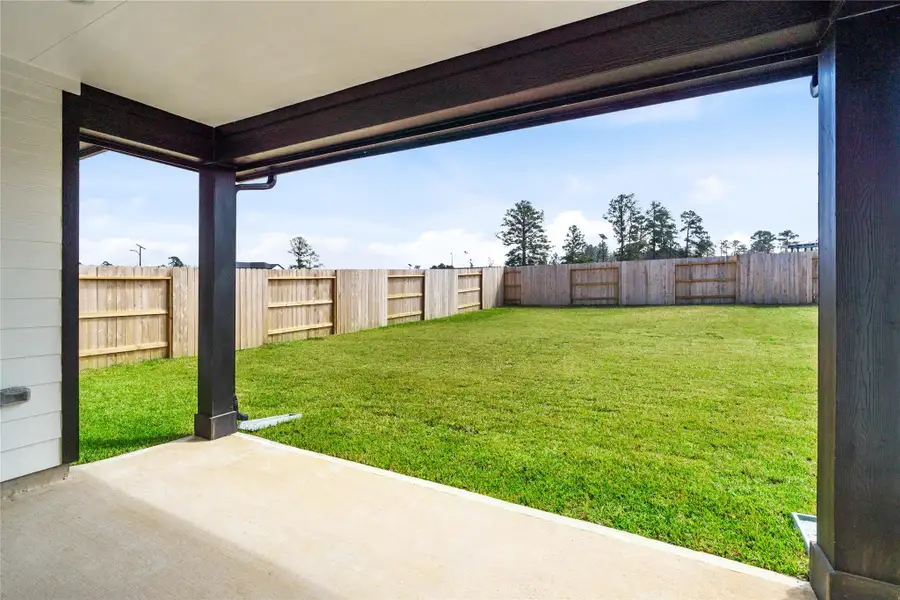 The spacious covered patio offers a tranquil outdoor retreat, perfectly designed for savoring your quiet morning coffee or unwinding during peaceful evening relaxation.