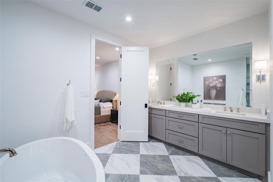 Bathroom featuring vanity and a washtub