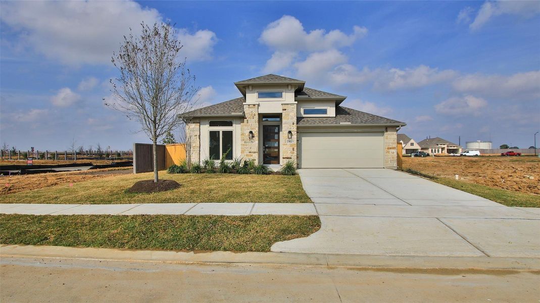 Front exterior of a new home in The Grand Prairie 50', Hockley, TX, highlighting curb appeal (Image 2).