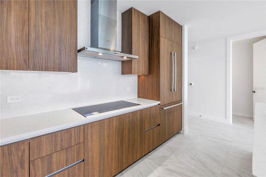 Kitchen with ample cabinetry and paneled refrigerator