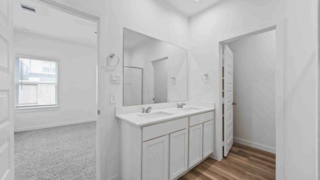 Representative furnished interior of a home built from the Magnolia by D.R. Horton in Grand West, Houston (Image 11).