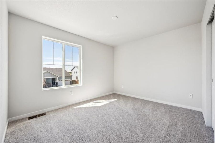 A room with a window and a carpet. A room with a window and a carpet.