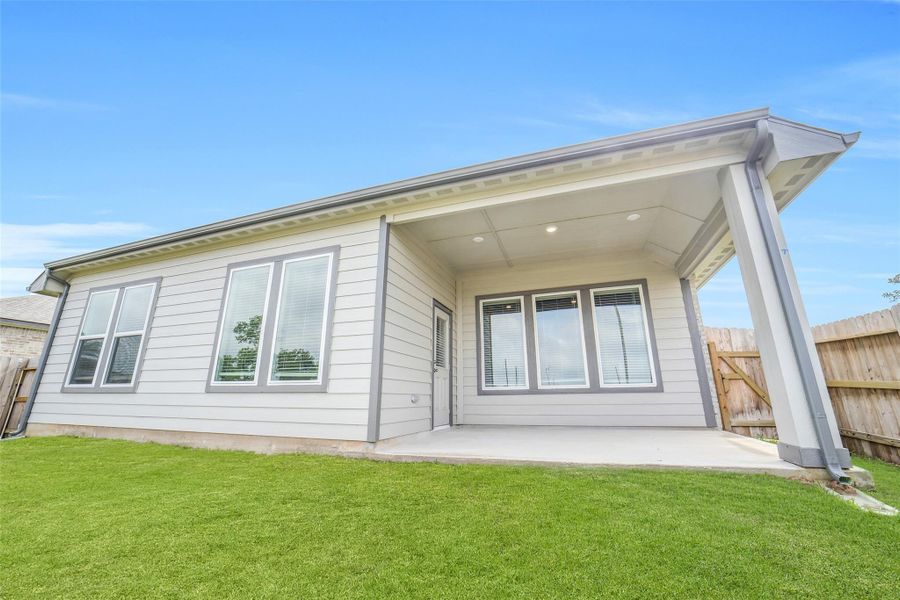 Exterior details and patio area of a home in Windmill Estates, Magnolia (Image 4).