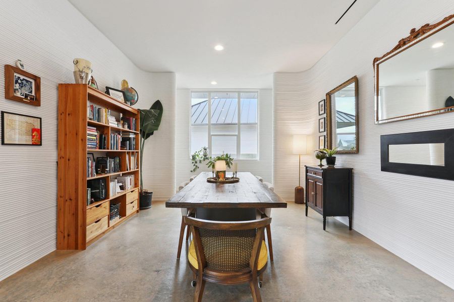 Dining area with finished concrete flooring and recessed lighting