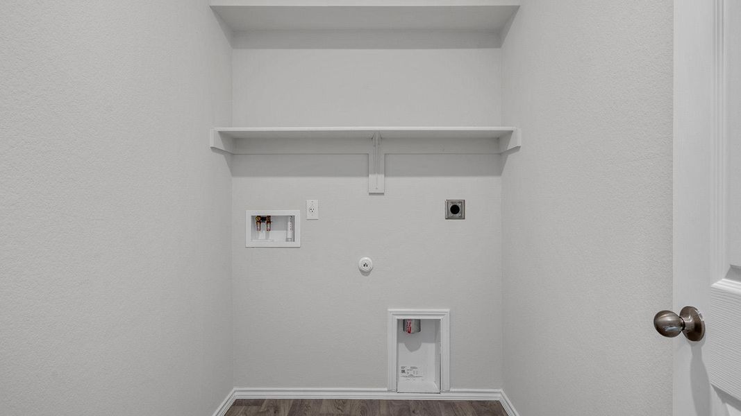 Laundry area featuring gas dryer hookup, hookup for a washing machine, electric dryer hookup, wood finished floors, and a textured wall