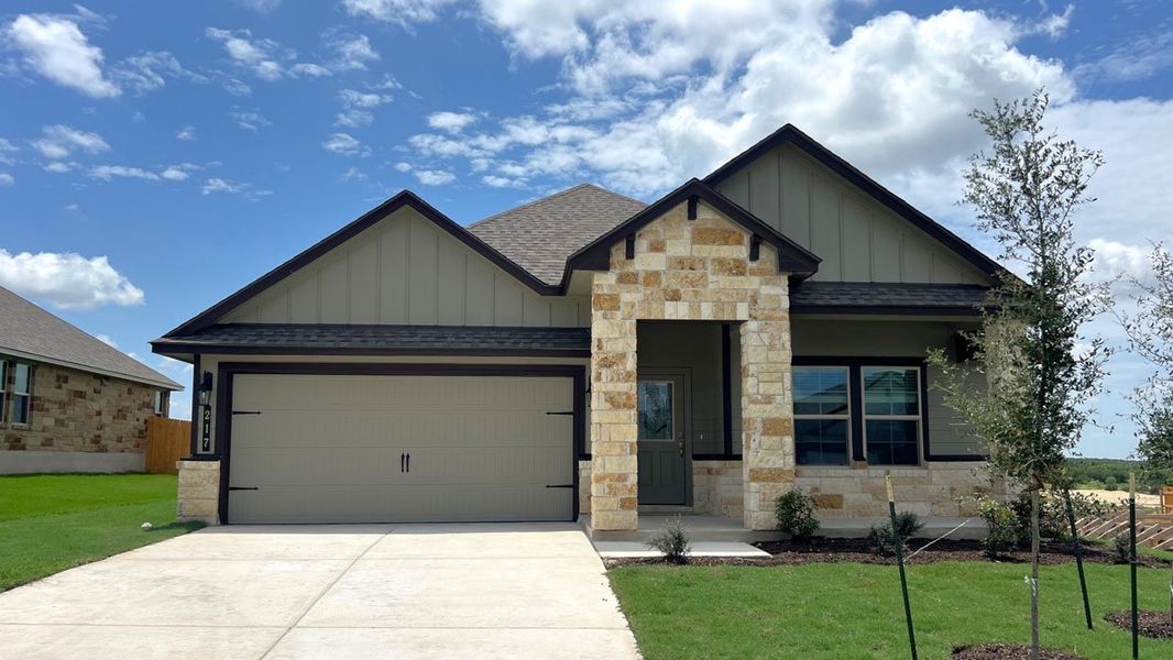Front exterior of a new home in Creekfall, Burnet, TX, highlighting curb appeal (Image 1).